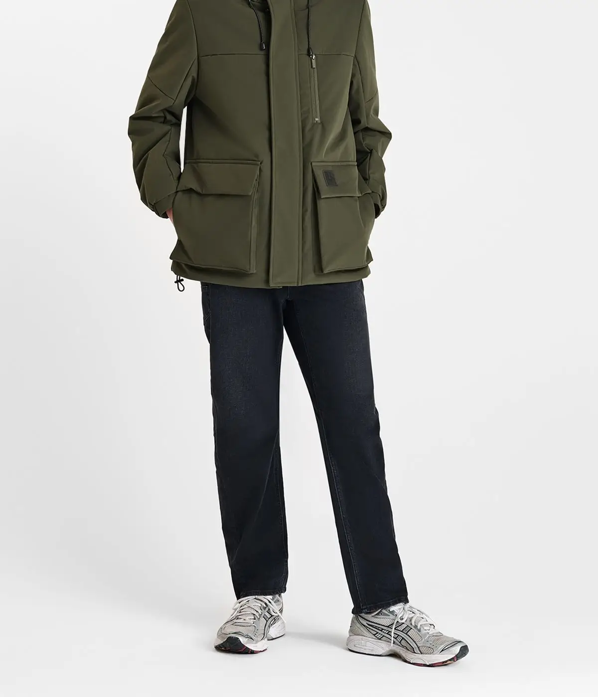 High-end ecommerce photo retouching service example showing a man wearing a green jacket and black trousers.