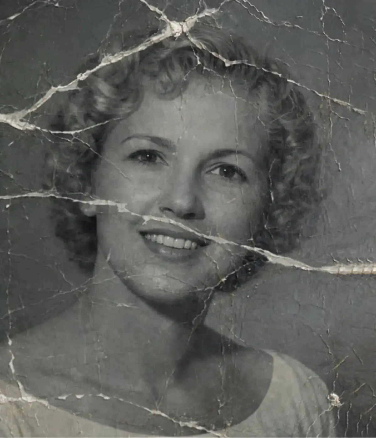 Professional old photo restoration service for a damaged vintage portrait of a woman